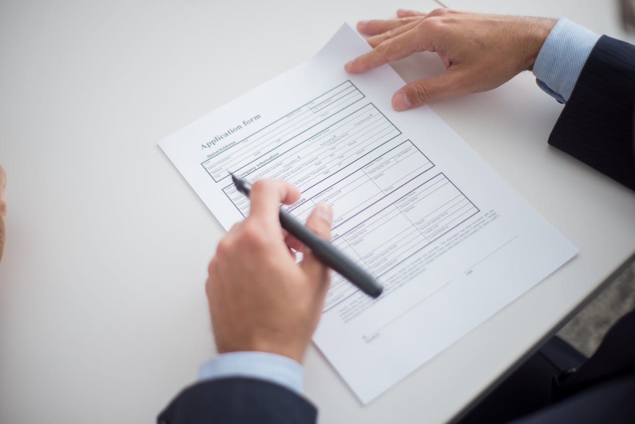 gallery-2 Close-up of a business professional reviewing an application form at a desk.